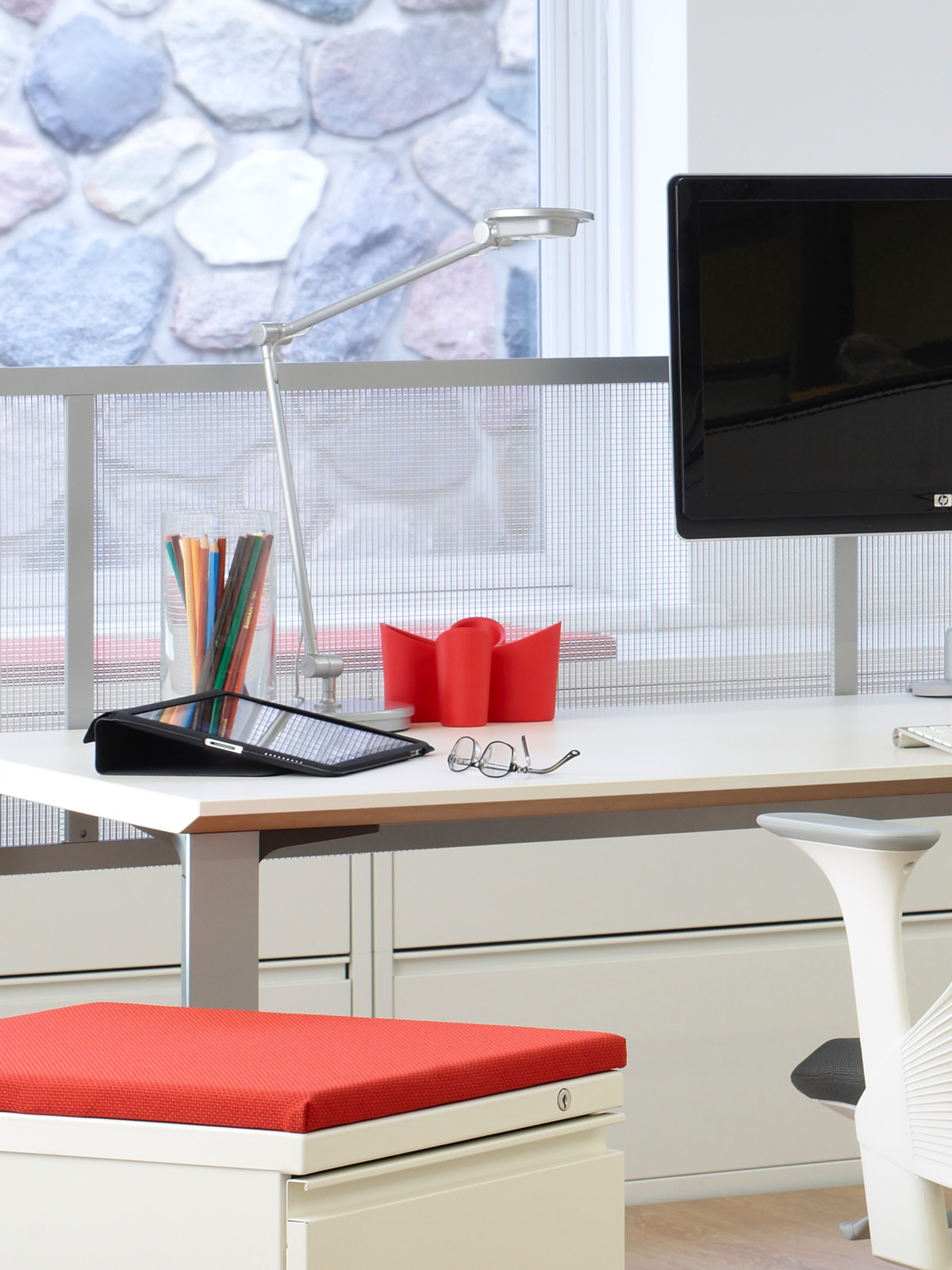 A desktop supports a computer, organizers, and a space-saving Tone Personal Light.