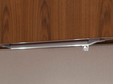 A slim, tubular Twist LED Task Light mounted beneath overhead storage.