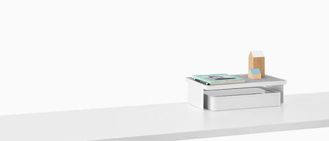 A Ubi Freestanding Shelf with personal items on top and a storage box below.