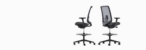 Two black Verus Stools with suspension back viewed from the side and back angle.