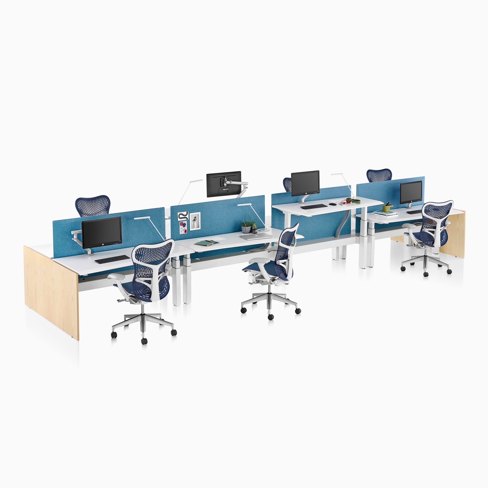 A side view of four Renew Link sit-to-stand desks with blue Sayl Chairs and divided by a blue screen. Select to go to the Renew Link product page. 