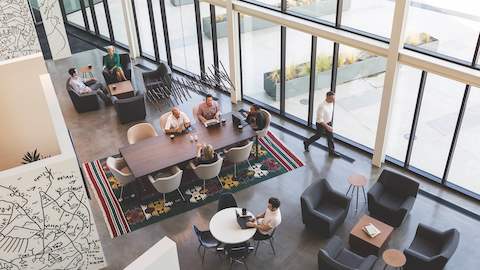 An overhead view of an office lounge area situated near windows. 