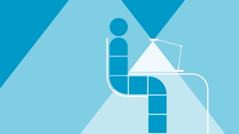 A geometric rendering of a figure seated at a desk in shades of blue and white. 