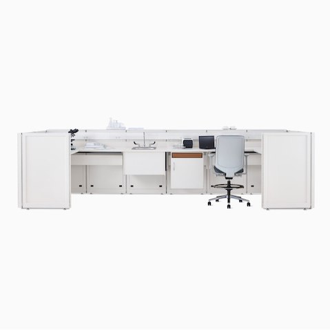 A Co/Struc System laboratory bench in soft white with under-surface storage, a sink, and a Verus Stool in light gray.