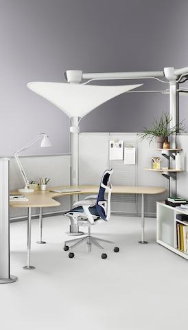An open, yet private, workstation formed from Resolve panels and featuring a curved work surface and blue Mirra 2 office chair.