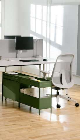Green OE1 Storage Trolley and Lino Chair pulled up to two grey OE1 Rectangular Tables joined together to form a bench. 