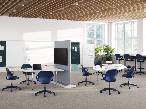 Zeph Chairs and Stools in blue with a selection of OE1 Workspace Collection products including OE1 Communal Table, OE1 Agile Wall and OE1 Huddle Table are featured in a workshop setting.