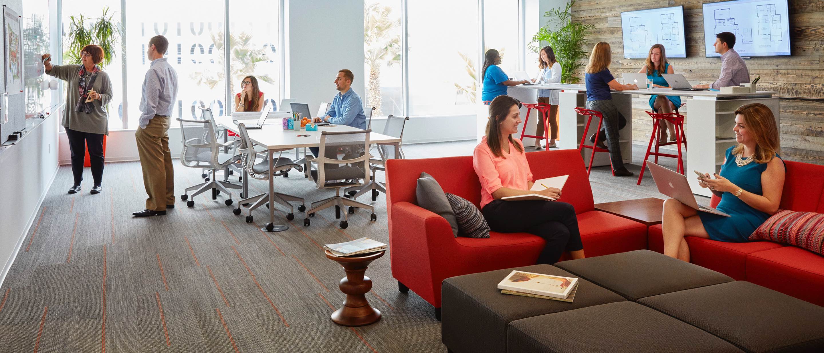 People work and converse in an open office setting with Setu Chairs and lounge seating.