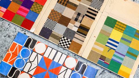 An overhead shot of colorful patterned textile samples and a graphic drawing of the Scoren House doors.