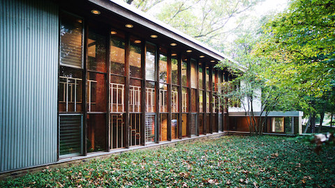 The exterior of a modern house with a wall of windows. Select to go to an article about a home designed by George Nelson.