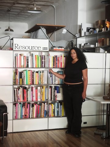 Resource founder Alison Beshai in front of Resource Lending Library shelves at the Lichen location.