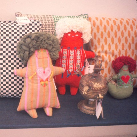 An archival photo of three colorful folk art dolls selected by Alexander Girard for the Textiles and Objects shop.